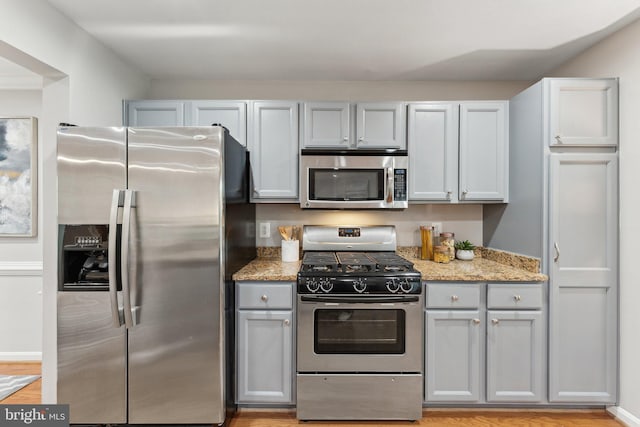 6603 Netties Ln Unit 1706, Alexandria, VA 22315 - kitchen featuring stainless steel appliances, gray cabinets, light stone countertops, and light wood finished floors