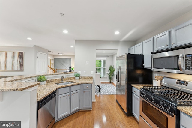 6603 Netties Ln Unit 1706, Alexandria, VA 22315 - kitchen featuring appliances with stainless steel finishes, a sink, light wood-type flooring, light stone countertops, and recessed lighting
