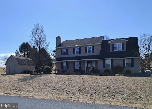 view of front facade with an outbuilding and a chimney