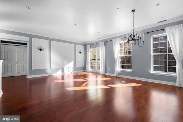 interior space featuring crown molding, wood finished floors, visible vents, and baseboards