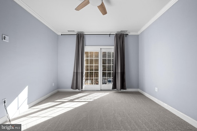 empty room with baseboards, carpet floors, ceiling fan, and crown molding