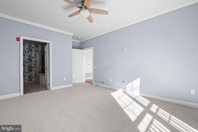 unfurnished bedroom with visible vents, baseboards, carpet, ornamental molding, and a ceiling fan