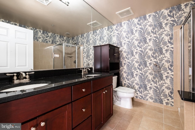 full bathroom featuring tile patterned floors, a shower stall, wallpapered walls, and a sink