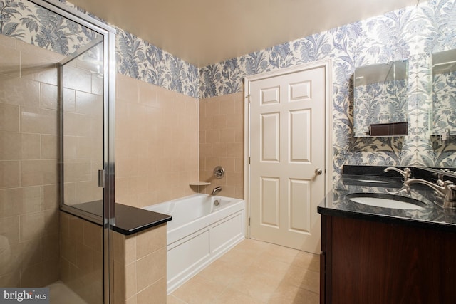 full bathroom with a sink, a bath, a stall shower, and wallpapered walls