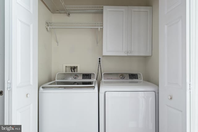 laundry room featuring washer and dryer and cabinet space