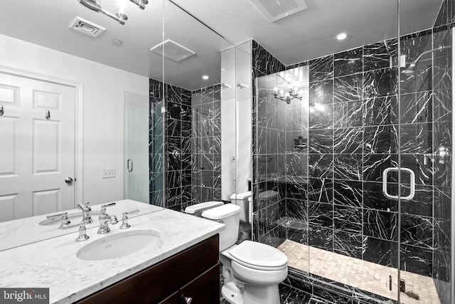 full bath featuring visible vents, a stall shower, toilet, and vanity