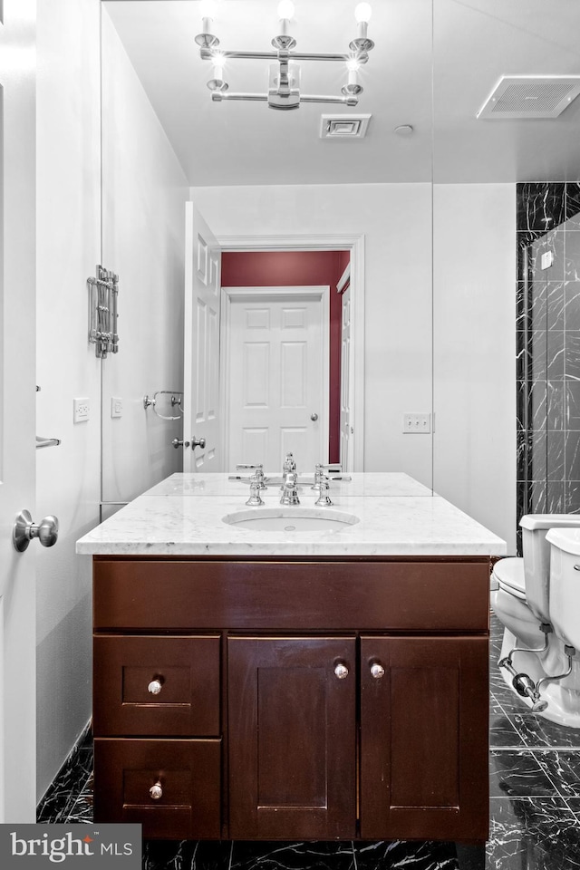 bathroom featuring visible vents, marble finish floor, and toilet