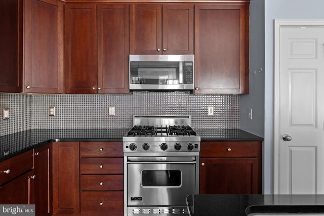 kitchen featuring stainless steel appliances and tasteful backsplash