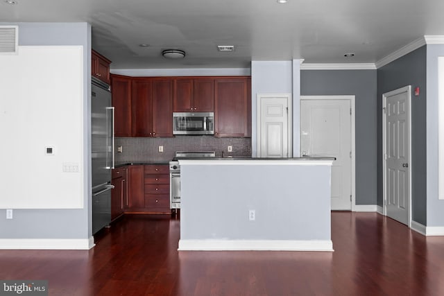 kitchen with backsplash, reddish brown cabinets, baseboards, high end appliances, and dark wood-style flooring