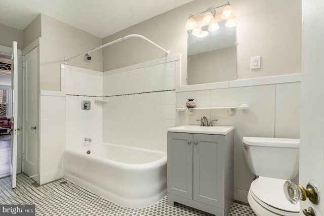 bathroom featuring vanity, shower / bathing tub combination, and toilet