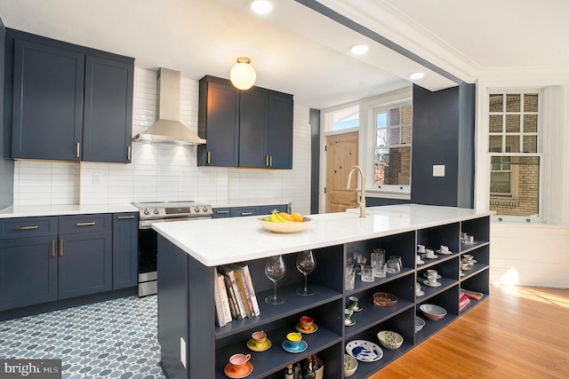 kitchen featuring open shelves, electric range, light countertops, wall chimney range hood, and backsplash