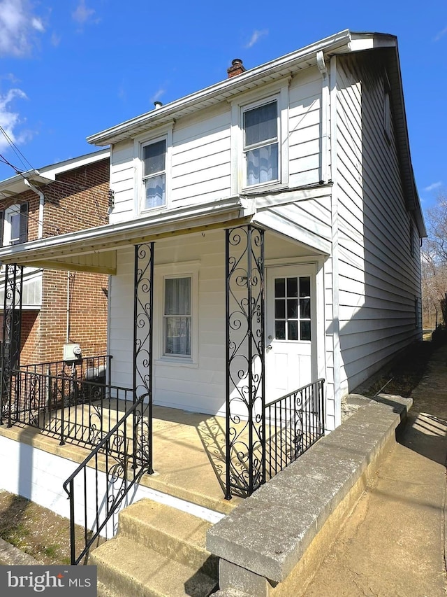 view of front of house with a porch and a chimney