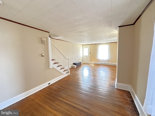 interior space featuring stairway, wood finished floors, baseboards, ornamental molding, and a baseboard heating unit