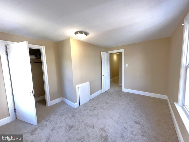 unfurnished bedroom featuring a closet, carpet flooring, and baseboards