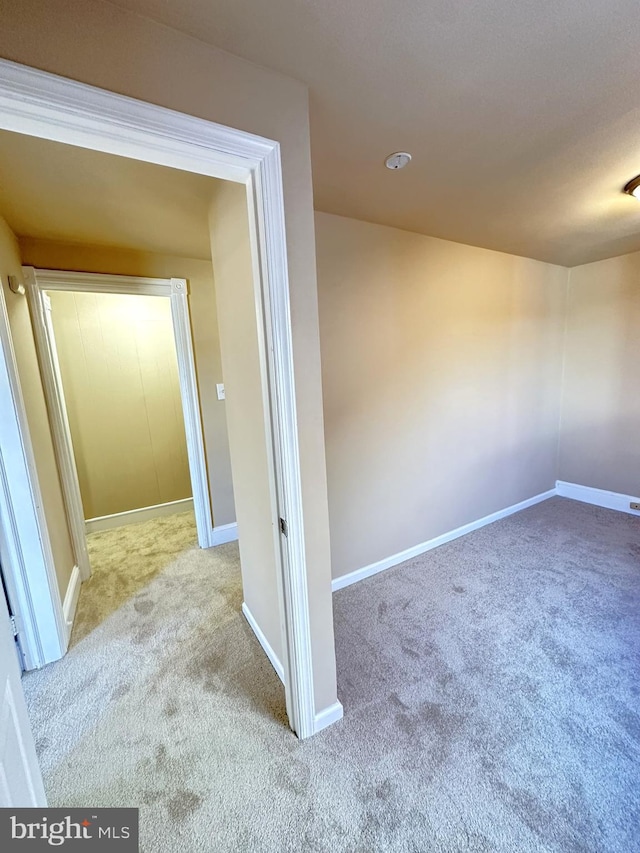 interior space with baseboards and carpet