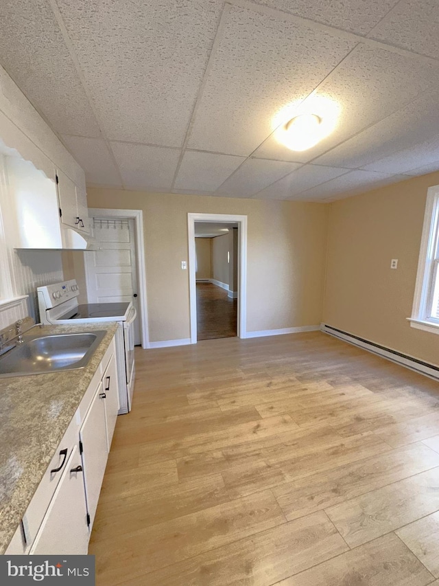 kitchen with a sink, white cabinetry, light wood finished floors, and white range with electric cooktop