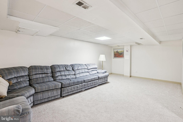 living area with carpet, visible vents, a drop ceiling, and baseboards