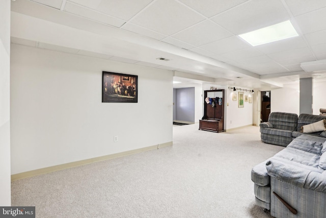 living room featuring carpet flooring, visible vents, a paneled ceiling, and baseboards