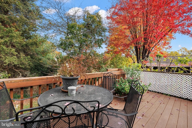 wooden deck featuring outdoor dining space