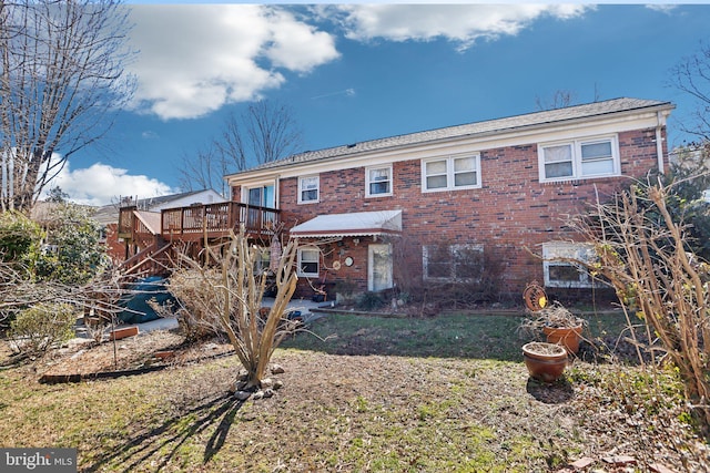 back of property featuring brick siding, stairs, and a deck