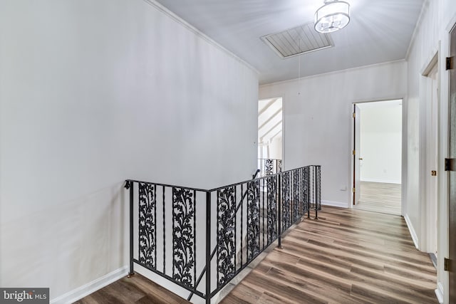 staircase with visible vents, attic access, baseboards, and wood finished floors