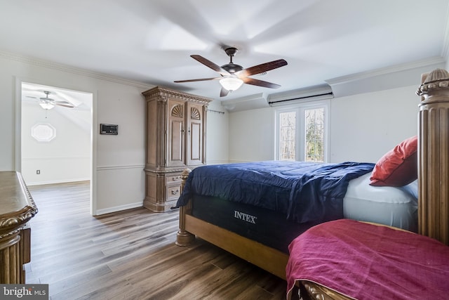 bedroom with ceiling fan, baseboards, wood finished floors, and ornamental molding