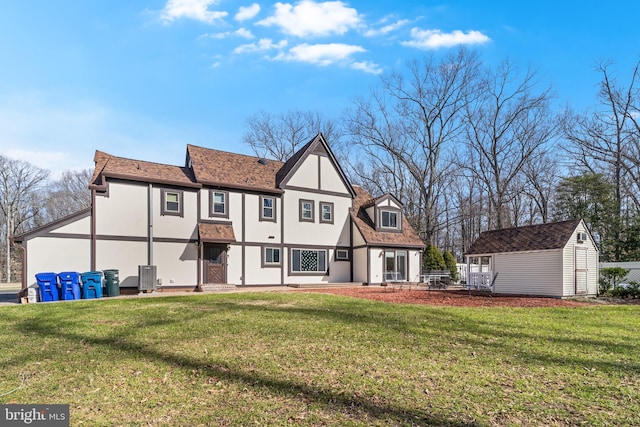 back of property featuring an outbuilding, stucco siding, a storage unit, and central AC