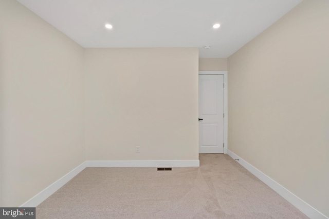 empty room with recessed lighting, baseboards, and light colored carpet