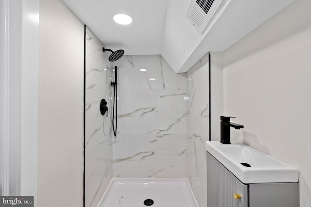 bathroom featuring a sink, a marble finish shower, and visible vents