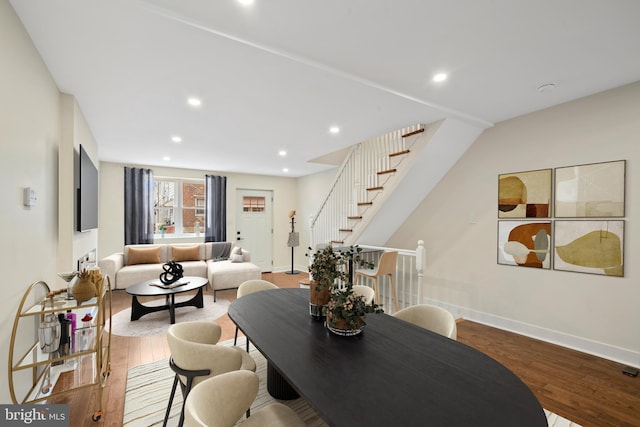 dining space featuring stairway, recessed lighting, baseboards, and wood finished floors