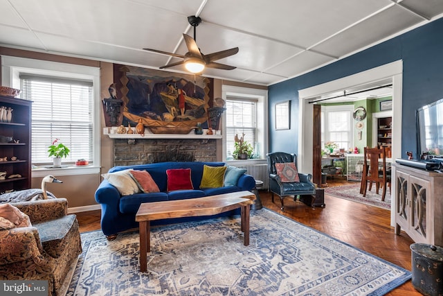 living room with radiator, baseboards, and ceiling fan