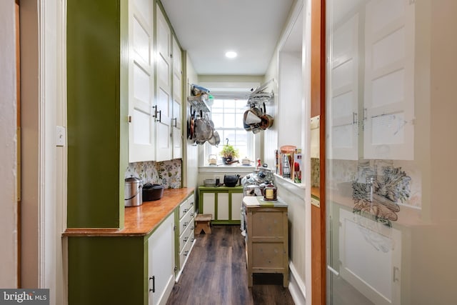 kitchen featuring white cabinetry and dark wood-type flooring