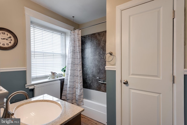 bathroom with vanity, radiator, and shower / tub combo with curtain