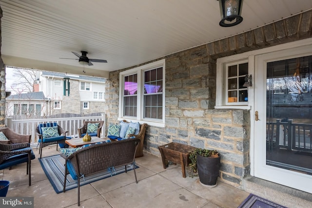 view of patio with an outdoor living space and a ceiling fan