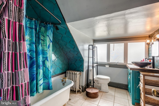 full bath featuring radiator, toilet, a tub to relax in, tile patterned floors, and vanity