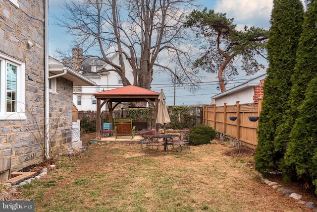 view of yard featuring a gazebo, a fenced backyard, and a patio area