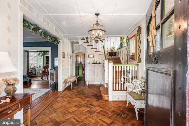 foyer featuring arched walkways, an inviting chandelier, and stairs