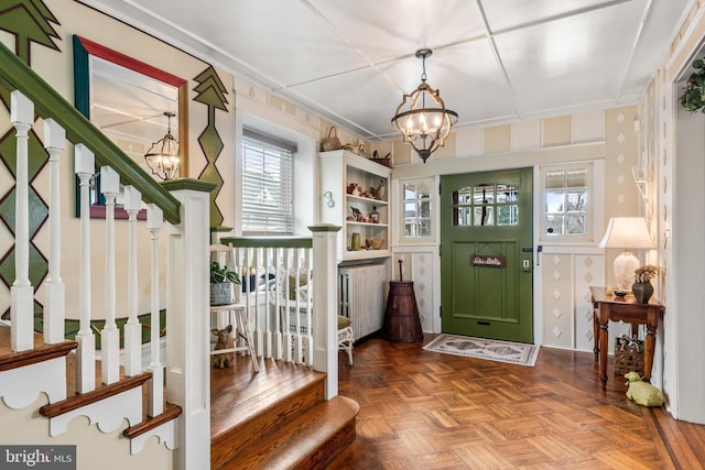 foyer with stairway and a chandelier