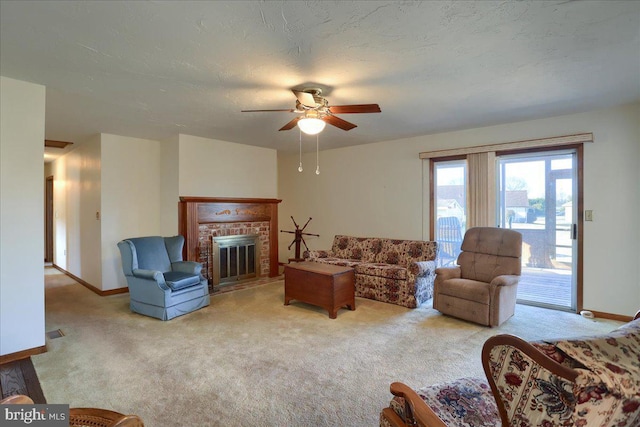 living area with a brick fireplace, baseboards, and carpet floors