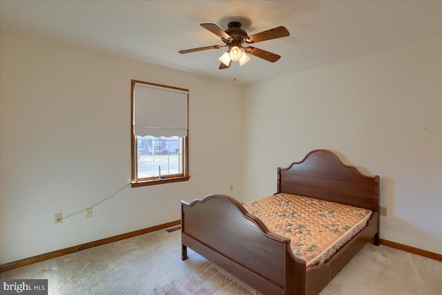 bedroom with light carpet, visible vents, and baseboards