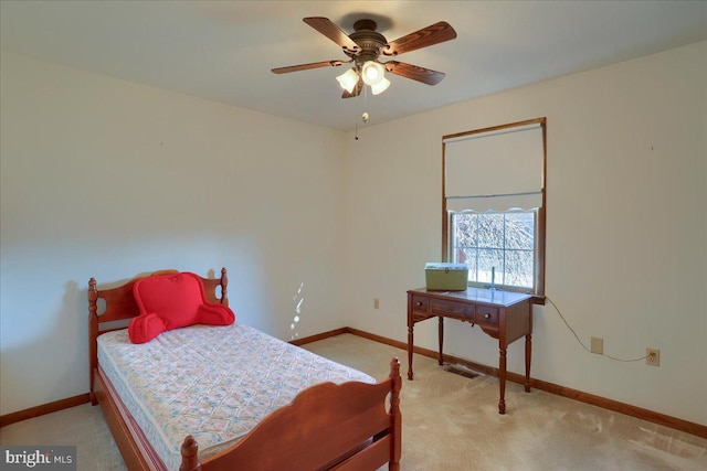 bedroom with baseboards and light carpet