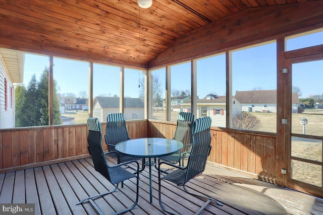 sunroom / solarium with lofted ceiling, wood ceiling, and a residential view