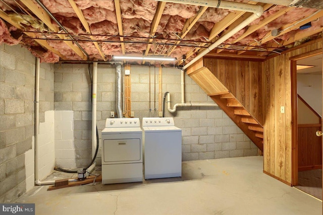 unfinished basement featuring independent washer and dryer and stairs