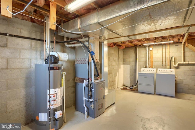 unfinished below grade area featuring water heater, heating unit, and separate washer and dryer