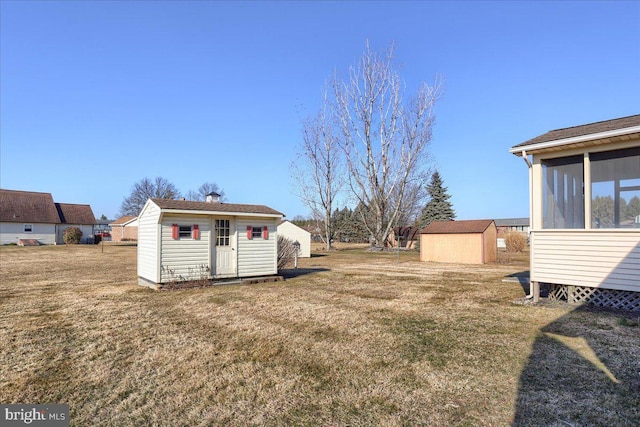 view of yard with a storage shed and an outdoor structure