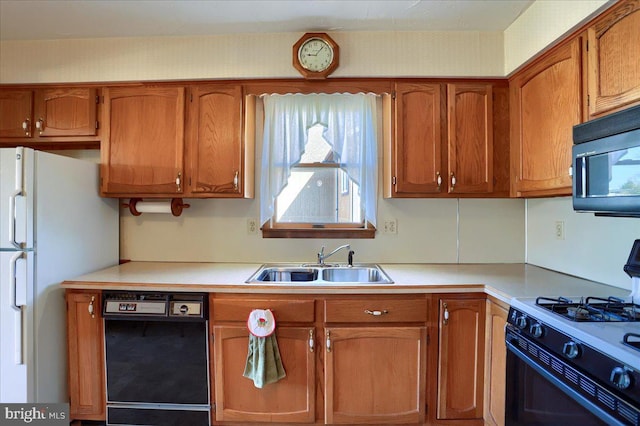 kitchen featuring a sink, black appliances, brown cabinetry, and light countertops