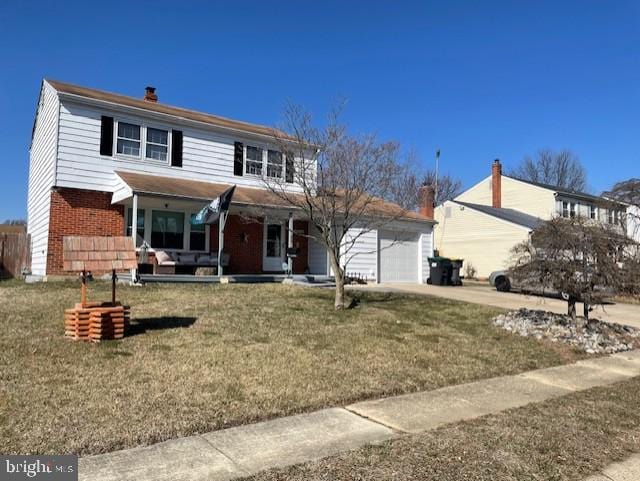 view of front of home with an attached garage, a chimney, a front lawn, concrete driveway, and brick siding