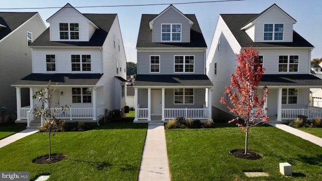 view of front of property with a porch, board and batten siding, and a front yard