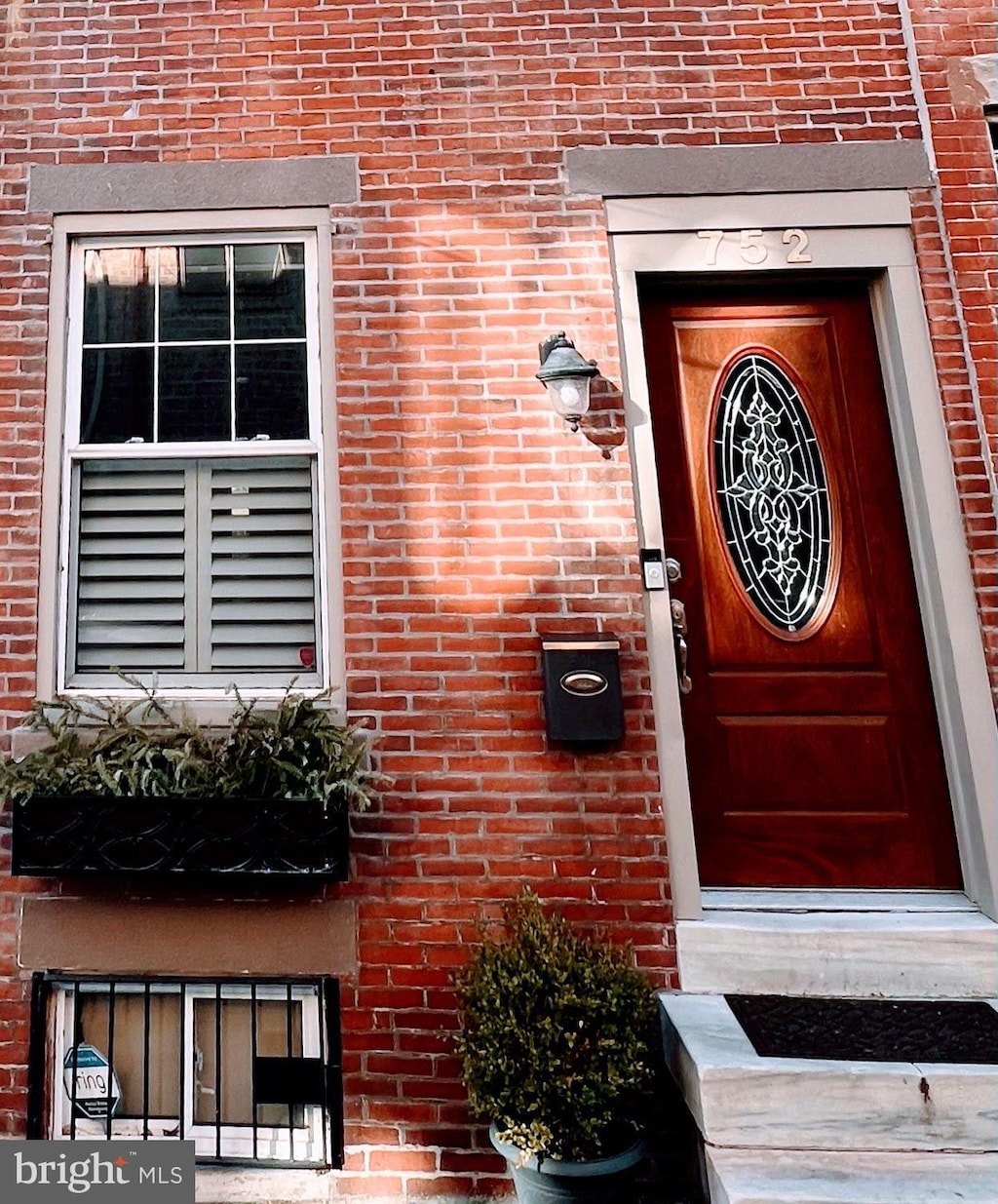 view of exterior entry with brick siding