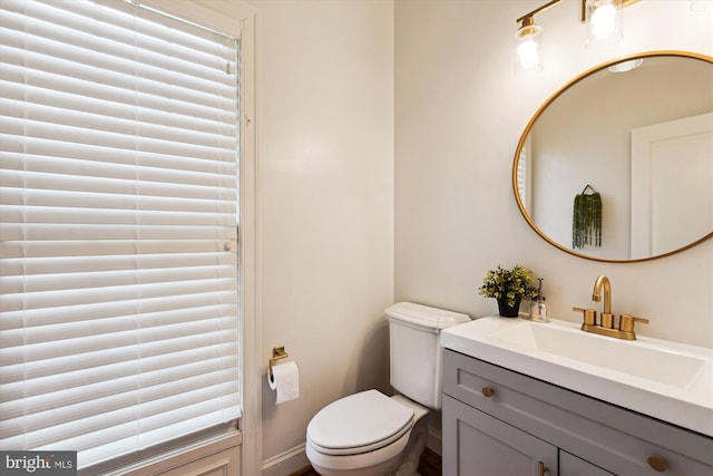 half bath featuring toilet and vanity